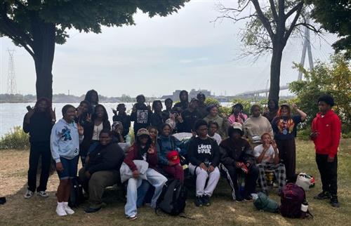  students posing at the Historic Fort Wayne in front of the Detroit River